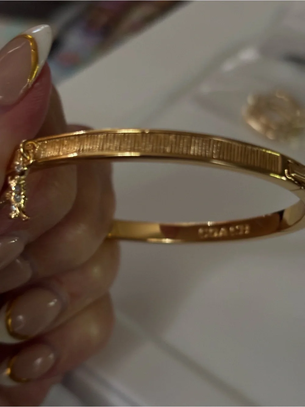 Coach Gold-Tone Textured Bangle with Star Crystal Accent Rexy